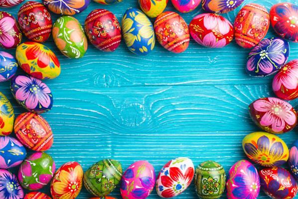 Painted Easter Eggs on Wood Background