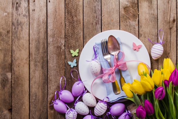 Table with Easter Eggs and Decorative Flowers Background